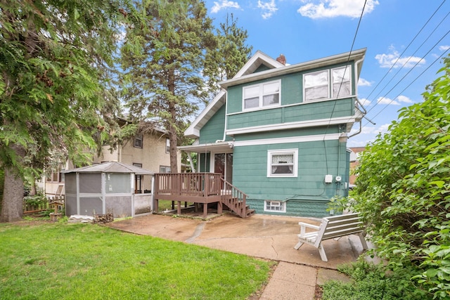 1027 Van Slyke Ave, Saint Paul, MN 55103 - rear view of house featuring a patio, a lawn, a deck, and a chimney