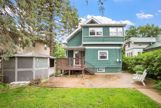 1027 Van Slyke Ave, Saint Paul, MN 55103 - back of property with a patio area, a yard, and a wooden deck