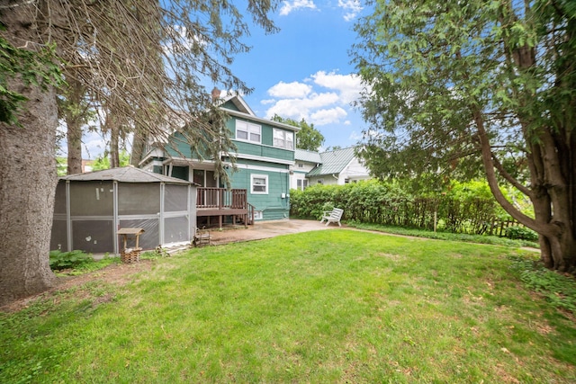 1027 Van Slyke Ave, Saint Paul, MN 55103 - view of green lawn with a patio and a deck