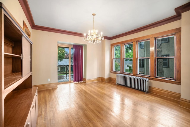 1027 Van Slyke Ave, Saint Paul, MN 55103 - unfurnished room featuring radiator, healthy amount of natural light, a chandelier, baseboards, and ornamental molding