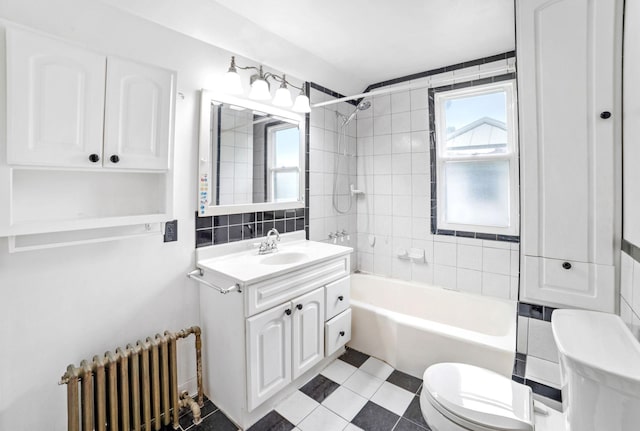 1027 Van Slyke Ave, Saint Paul, MN 55103 - full bathroom featuring radiator heating unit, toilet, vanity, shower / washtub combination, and plenty of natural light