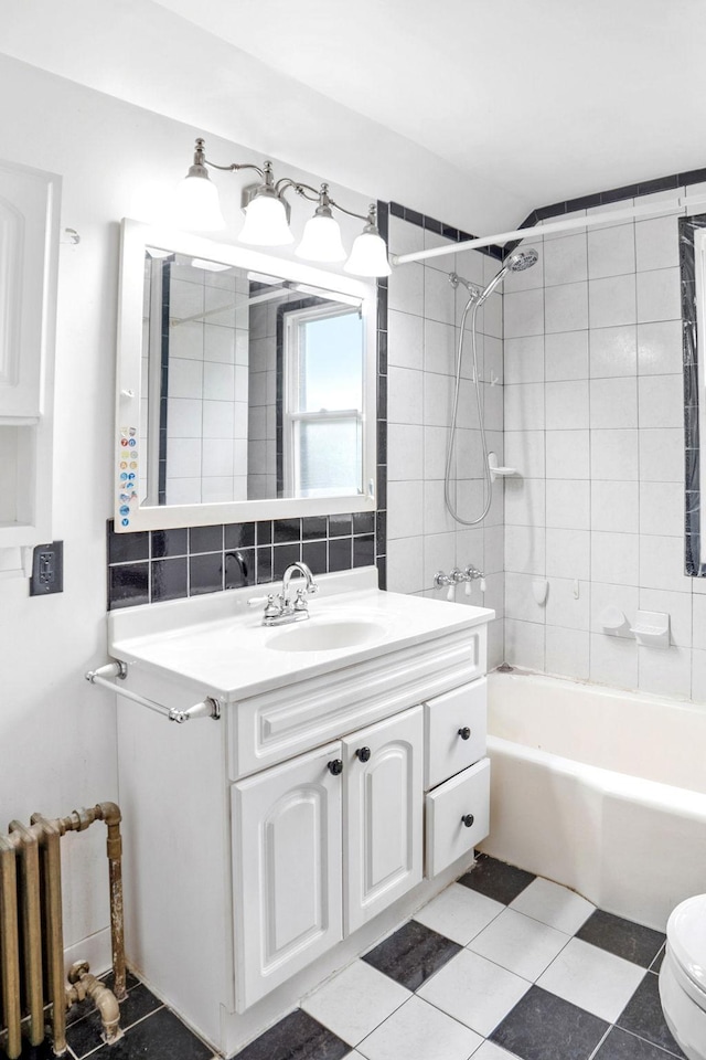 1027 Van Slyke Ave, Saint Paul, MN 55103 - full bath with vanity, bathtub / shower combination, toilet, radiator, and tasteful backsplash