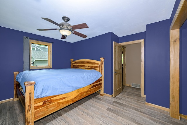 1424 Summit Ave, Cloquet, MN 55720 - bedroom featuring baseboards, wood finished floors, and a ceiling fan