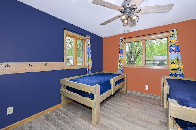 1424 Summit Ave, Cloquet, MN 55720 - bedroom with multiple windows, wood finished floors, and baseboards