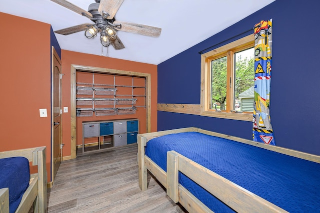 1424 Summit Ave, Cloquet, MN 55720 - bedroom featuring wood finished floors, a ceiling fan, and baseboards