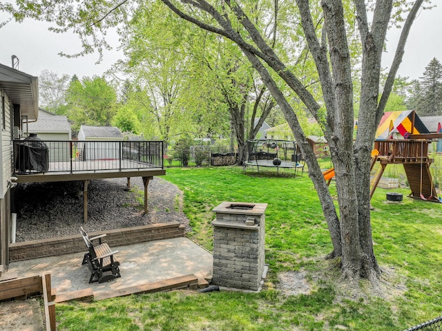 1424 Summit Ave, Cloquet, MN 55720 - view of yard featuring a trampoline, a playground, and a wooden deck