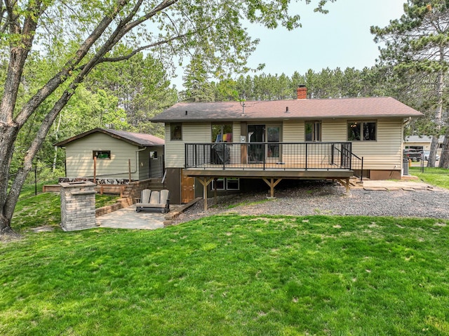 1424 Summit Ave, Cloquet, MN 55720 - back of property featuring a wooden deck, a lawn, a chimney, and a patio