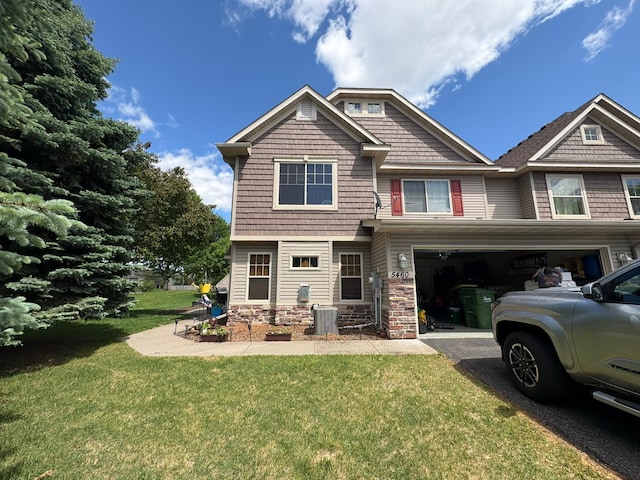 5460 100th Ln N, Brooklyn Park, MN 55443 - rear view of property featuring an attached garage, a lawn, and asphalt driveway