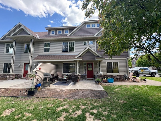 5460 100th Ln N, Brooklyn Park, MN 55443 - view of front of home with a front yard, an outdoor living space, a patio area, and a shingled roof