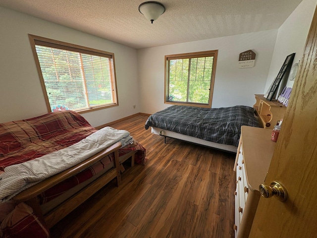 5460 100th Ln N, Brooklyn Park, MN 55443 - bedroom with wood finished floors, multiple windows, and a textured ceiling
