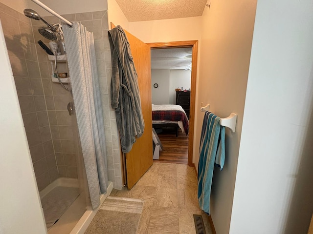 5460 100th Ln N, Brooklyn Park, MN 55443 - full bath featuring connected bathroom, a textured ceiling, and a tile shower