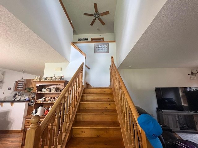 5460 100th Ln N, Brooklyn Park, MN 55443 - staircase featuring ceiling fan, wood finished floors, and a textured ceiling