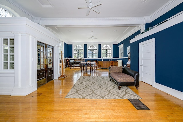 2306 5th St, Superior, WI 54880 - sitting room with light wood finished floors, crown molding, a ceiling fan, decorative columns, and beamed ceiling