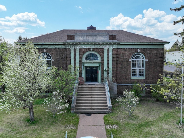 2306 5th St, Superior, WI 54880 - view of front of property with brick siding, a chimney, and a shingled roof