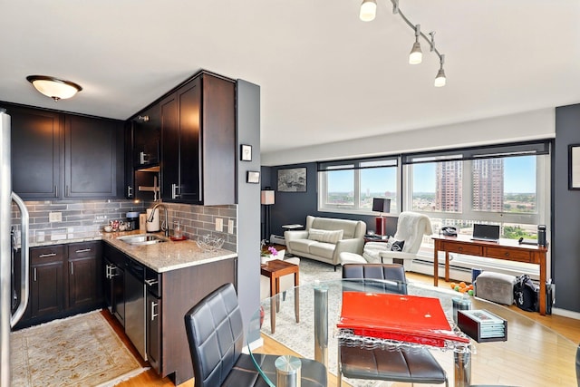 433 7th St Unit 1623, Minneapolis, MN 55415 - kitchen with stainless steel dishwasher, a sink, light stone countertops, and light wood finished floors