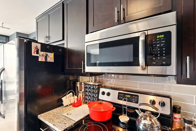 433 7th St Unit 1623, Minneapolis, MN 55415 - kitchen with appliances with stainless steel finishes, tasteful backsplash, and dark brown cabinets