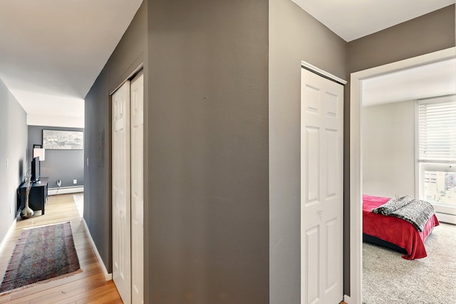 433 7th St Unit 1623, Minneapolis, MN 55415 - hallway with a baseboard radiator, baseboards, and light wood-type flooring