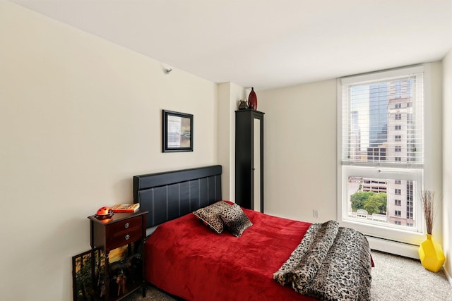 433 7th St Unit 1623, Minneapolis, MN 55415 - bedroom with a baseboard heating unit, multiple windows, and carpet