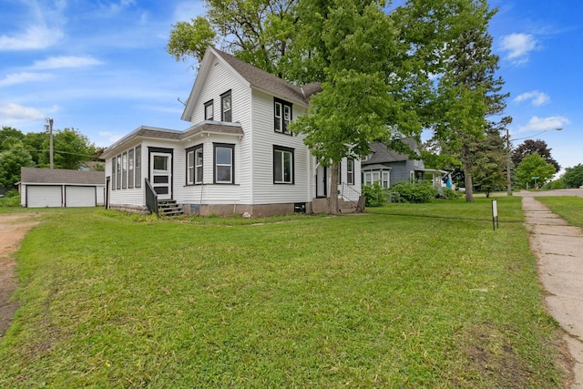 1319 Hennepin Ave N, Glencoe, MN 55336 - view of side of property featuring entry steps, an outdoor structure, a garage, and a yard