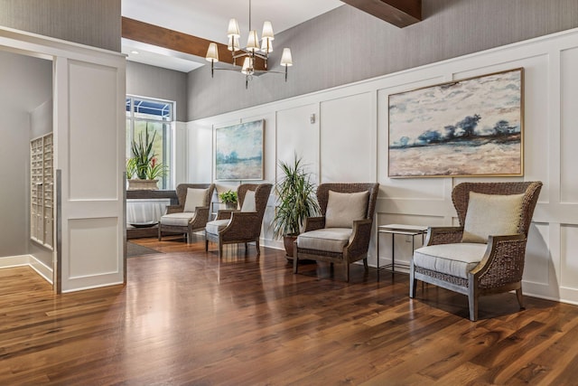 935 Lake St E Unit 211, Wayzata, MN 55391 - living area with a towering ceiling, a chandelier, wood finished floors, and a decorative wall