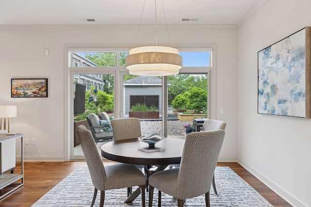 935 Lake St E Unit 211, Wayzata, MN 55391 - dining space with plenty of natural light, crown molding, dark wood finished floors, and a fireplace