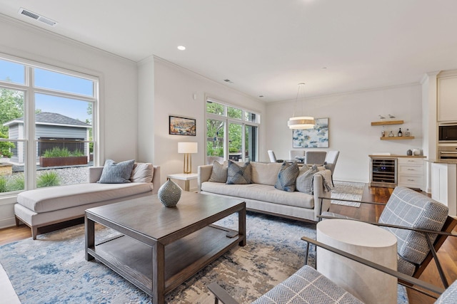 935 Lake St E Unit 211, Wayzata, MN 55391 - living area featuring wine cooler, wood finished floors, ornamental molding, and recessed lighting