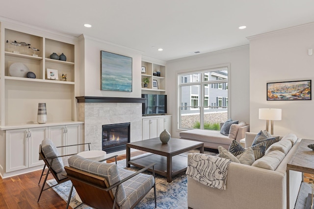 935 Lake St E Unit 211, Wayzata, MN 55391 - living room with crown molding, wood finished floors, a tile fireplace, built in shelves, and recessed lighting