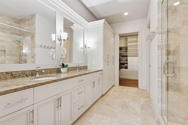 935 Lake St E Unit 211, Wayzata, MN 55391 - bathroom featuring double vanity, a stall shower, a spacious closet, and recessed lighting