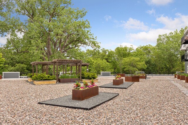 935 Lake St E Unit 211, Wayzata, MN 55391 - view of patio featuring a pergola and a garden