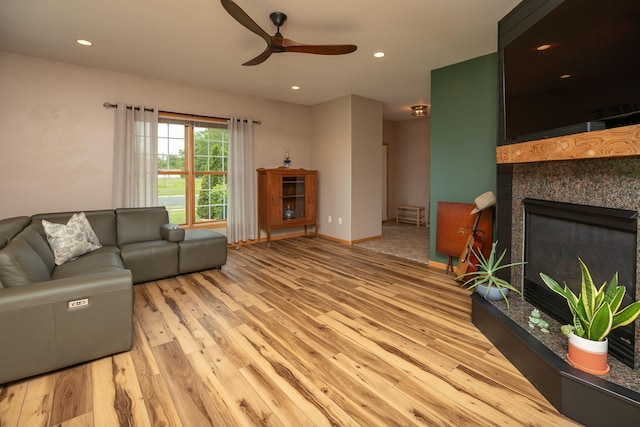 106 9th Ave SE, Kasson, MN 55944 - living area featuring a ceiling fan, light wood-style floors, a glass covered fireplace, recessed lighting, and baseboards