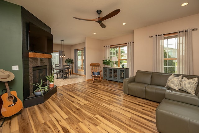 106 9th Ave SE, Kasson, MN 55944 - living room featuring light wood finished floors, ceiling fan, recessed lighting, and a tiled fireplace