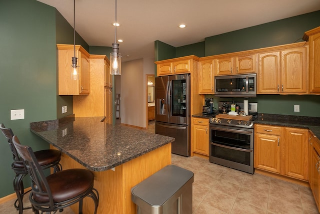 106 9th Ave SE, Kasson, MN 55944 - kitchen with stainless steel appliances, a kitchen breakfast bar, a peninsula, recessed lighting, and hanging light fixtures