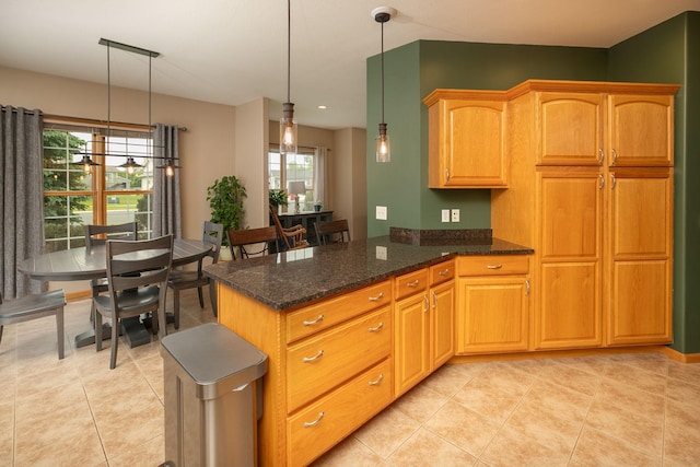 106 9th Ave SE, Kasson, MN 55944 - kitchen with healthy amount of natural light, dark stone countertops, a peninsula, and decorative light fixtures