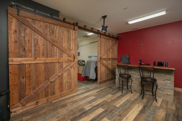 106 9th Ave SE, Kasson, MN 55944 - bar with a barn door, wood finished floors, and baseboards