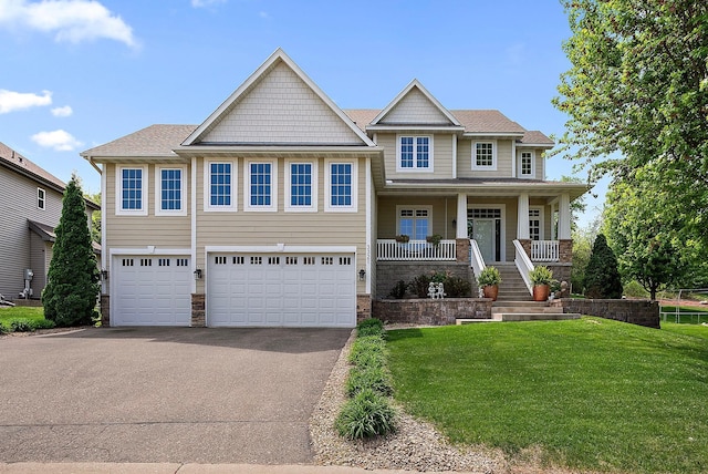 3321 Willie Dr, Burnsville, MN 55337 - craftsman house with driveway, an attached garage, a front lawn, a porch, and stone siding