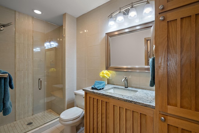 3321 Willie Dr, Burnsville, MN 55337 - bathroom with tile walls, vanity, toilet, a stall shower, and decorative backsplash