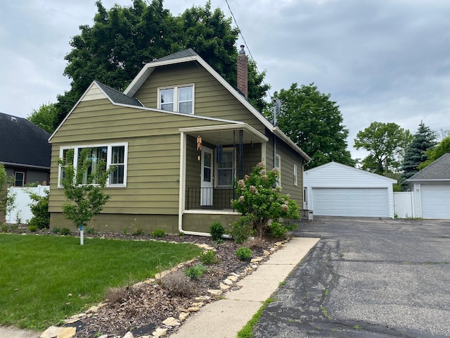 219 9th Ave SE, Rochester, MN 55904 - bungalow-style home with a garage, covered porch, a chimney, an outdoor structure, and a front yard