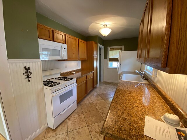 219 9th Ave SE, Rochester, MN 55904 - kitchen with white appliances, a sink, brown cabinets, and dark countertops