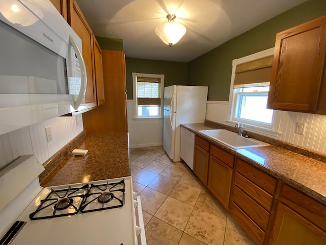 219 9th Ave SE, Rochester, MN 55904 - kitchen with white appliances, a sink, brown cabinets, and healthy amount of natural light