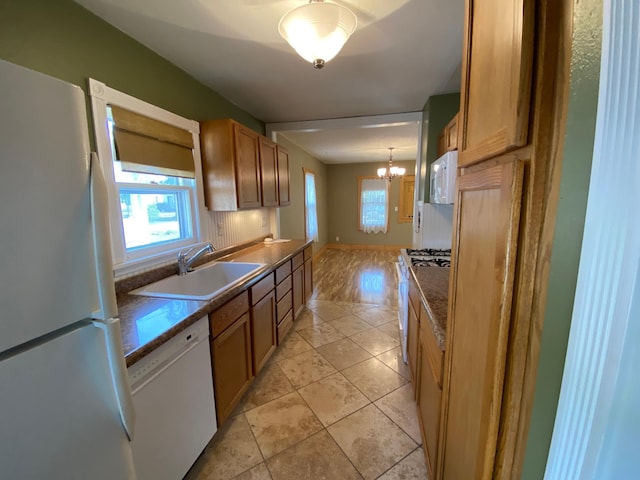 219 9th Ave SE, Rochester, MN 55904 - kitchen featuring white appliances, a sink, a chandelier, and brown cabinetry