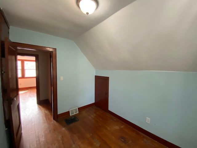 219 9th Ave SE, Rochester, MN 55904 - additional living space featuring dark wood-style floors, lofted ceiling, and baseboards