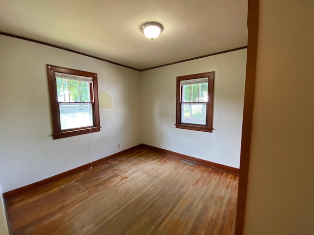 219 9th Ave SE, Rochester, MN 55904 - unfurnished room with wood finished floors, healthy amount of natural light, ornamental molding, and baseboards
