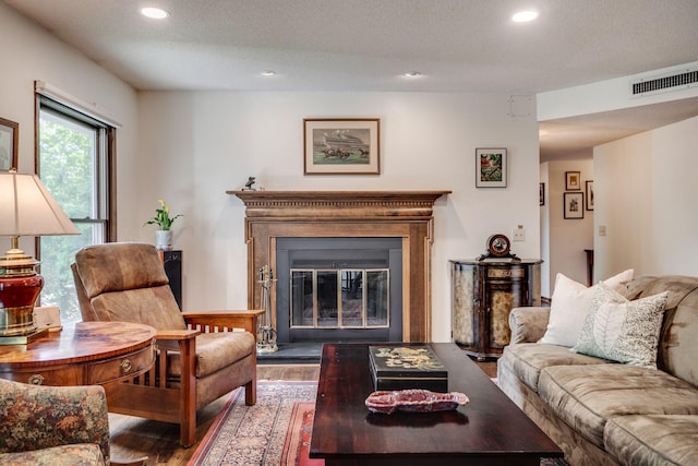 3020 Saint Albans Mill Rd Unit 309, Minnetonka, MN 55305 - living area with a glass covered fireplace, wood finished floors, recessed lighting, and a textured ceiling