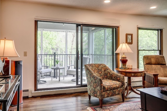 3020 Saint Albans Mill Rd Unit 309, Minnetonka, MN 55305 - sitting room featuring wood finished floors, healthy amount of natural light, recessed lighting, a textured ceiling, and baseboard heating