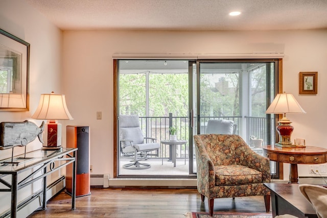 3020 Saint Albans Mill Rd Unit 309, Minnetonka, MN 55305 - living area with wood finished floors, a baseboard radiator, a textured ceiling, recessed lighting, and a baseboard heating unit