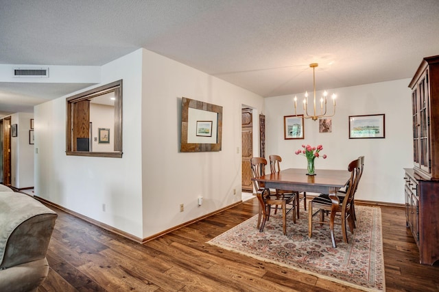 3020 Saint Albans Mill Rd Unit 309, Minnetonka, MN 55305 - dining space with a chandelier, dark wood-type flooring, a textured ceiling, and baseboards