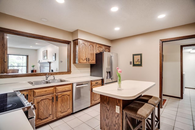 3020 Saint Albans Mill Rd Unit 309, Minnetonka, MN 55305 - kitchen featuring a sink, stainless steel appliances, a breakfast bar, light countertops, and light tile patterned floors