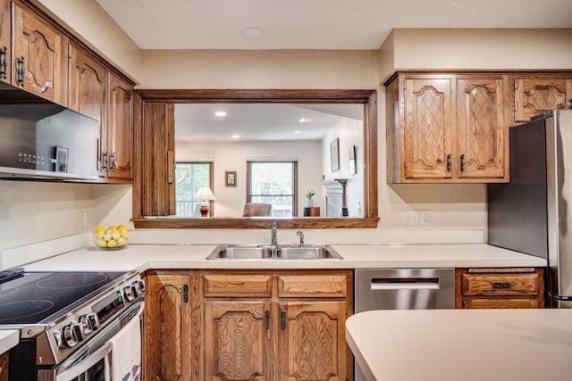 3020 Saint Albans Mill Rd Unit 309, Minnetonka, MN 55305 - kitchen with a sink, appliances with stainless steel finishes, brown cabinets, light countertops, and recessed lighting