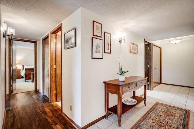 3020 Saint Albans Mill Rd Unit 309, Minnetonka, MN 55305 - corridor featuring a textured ceiling, baseboards, and wood-type flooring