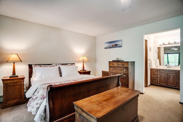 3020 Saint Albans Mill Rd Unit 309, Minnetonka, MN 55305 - bedroom featuring light colored carpet, ensuite bath, and a sink
